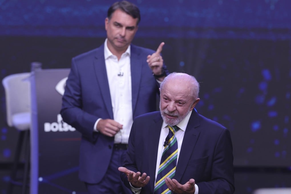 Opposition candidate Flavio Bolsonaro gestures behind Brazilian President Luiz Inacio Lula da Silva during their first face-to-face presidential debate. Photo: EPA