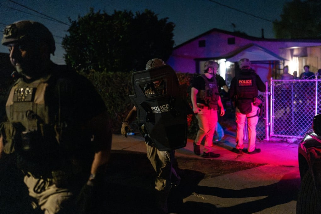 Homeland Security Investigations officers leave a home after arresting a suspect accused of illegally registering to vote during a federal operation in Commerce, California on Monday. Photo: AP