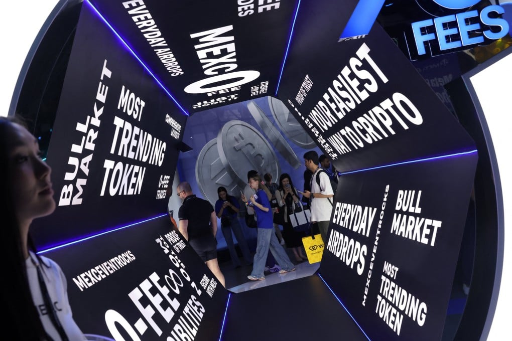 Attendees pass cryptocurrency signage at the Token2049 crypto conference in Singapore on October 1, 2025. Photo: Reuters