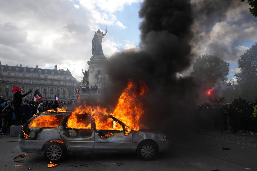 A car burns at Republique square in Paris on Saturday. Photo: AP