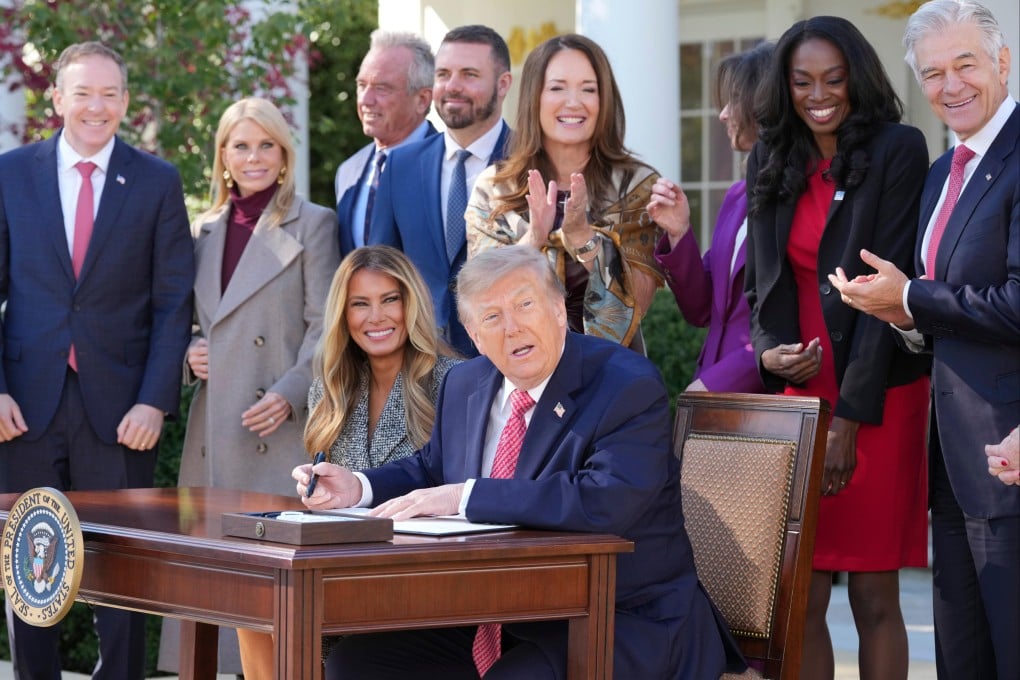 US President Donald Trump, seated with First Lady Melania Trump, signs an executive order during an event about women’s health in the Rose Garden of the White House in Washington on Monday. Photo: AP