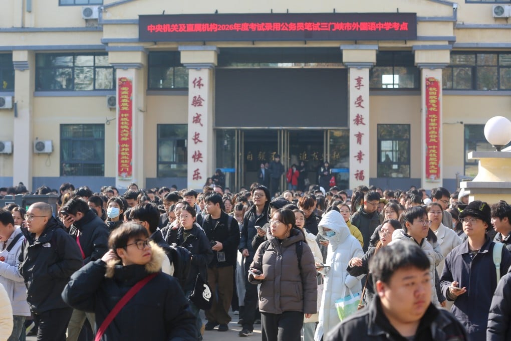 Candidates gather outside a national civil service examination centre in central China's Henan province in November last year. Photo: Getty Images