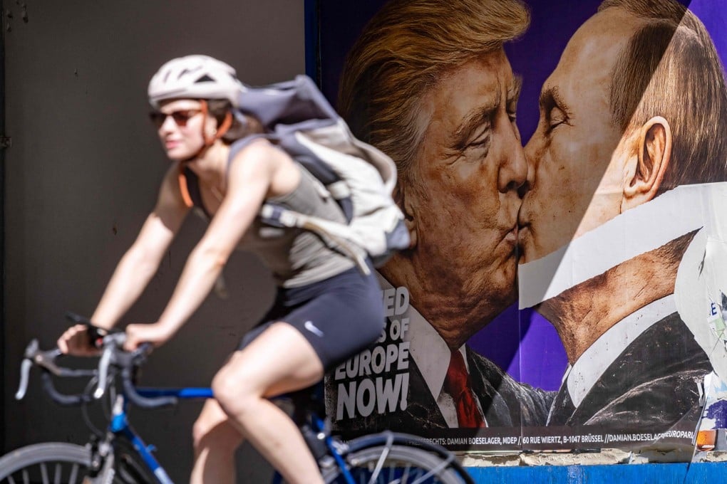 A woman cycles past a poster in Berlin, Germany, in June depicting US President Donald Trump and Russian President Vladimir Putin kissing. Photo: AFP