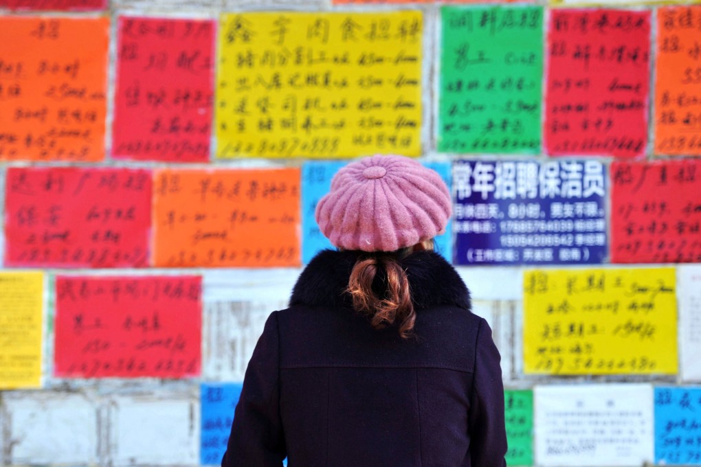 A woman studies a wall full of job adverts in Qingdao city. Photo: Reuters