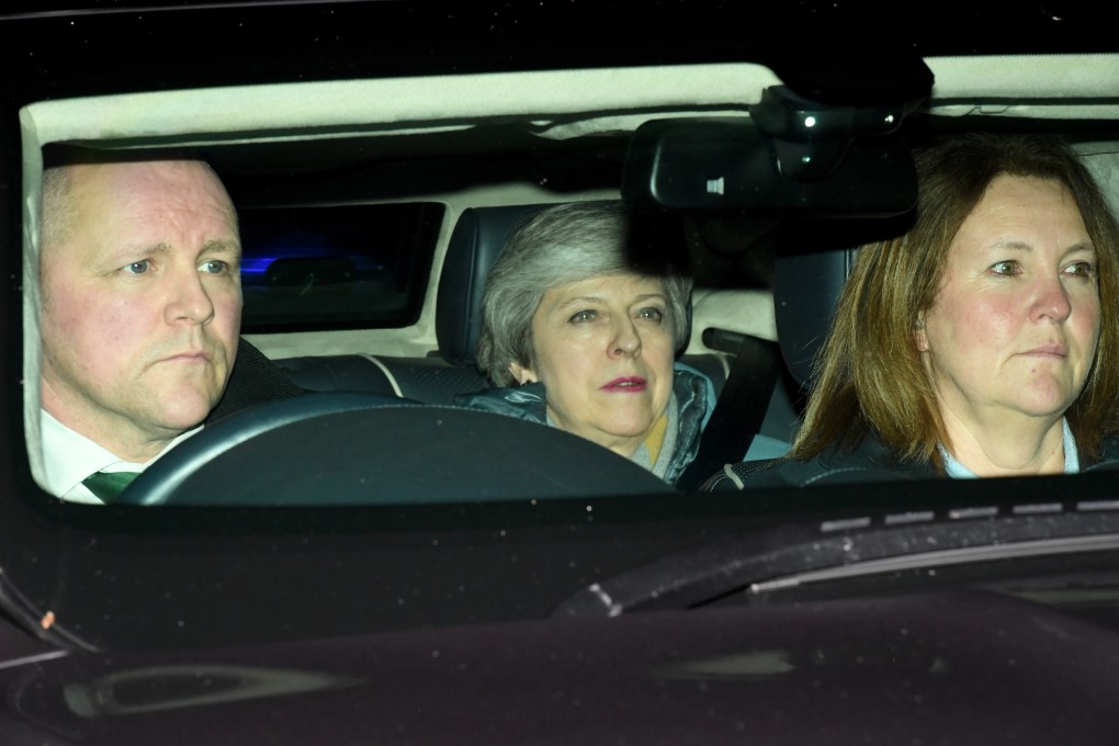 British Prime Minister Theresa May (centre) leaves the Houses of Parliament in London on Tuesday evening, after MPs voted 391 to 242 vote against her amended Brexit deal. Photo: EPA