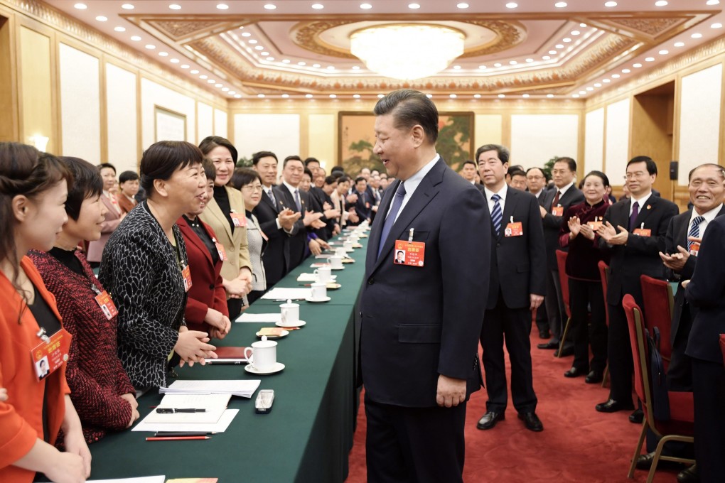 President Xi Jinping stops to talk to National People’s Congress deputies during a session of the annual meeting on March 8, in Beijing. Xi is determined that China must continue to champion globalisation. Photo: Xinhua