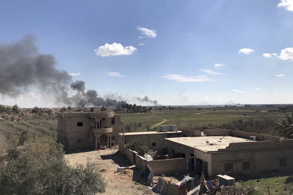 Columns of black smoke rise from the last small piece of territory held by Islamic State militants in Baghouz, Syria. Photo: AP