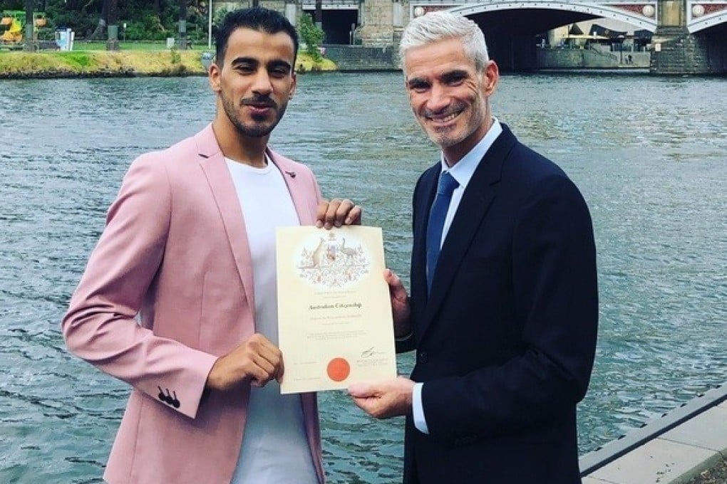 Hakeem al-Araibi and Craig Foster show off his Australian citizenship certificate.