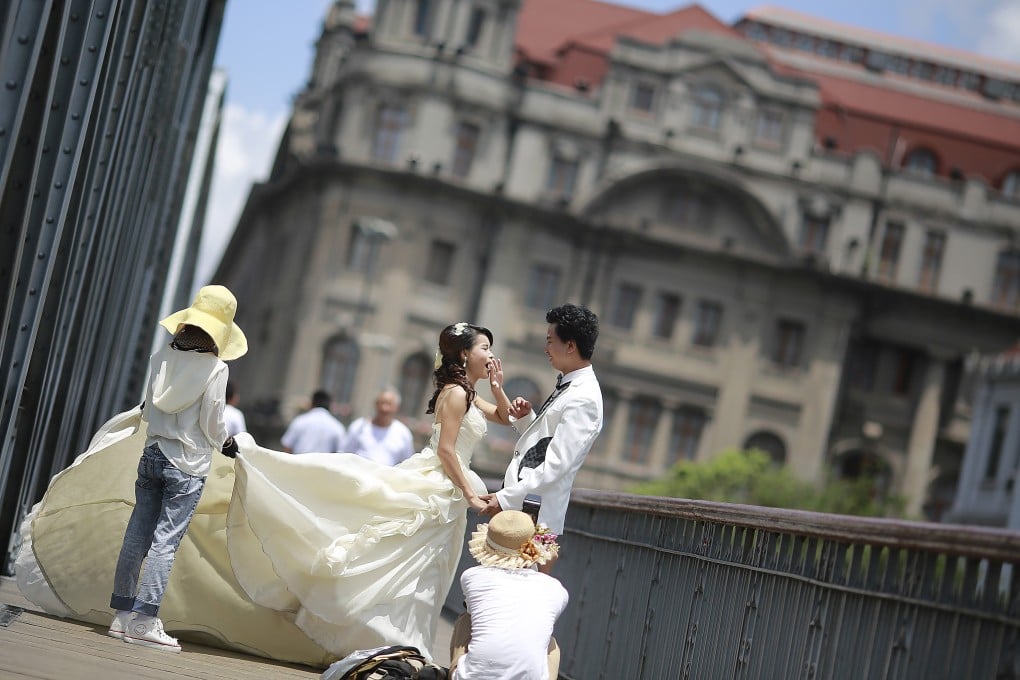 Newlyweds pose for photos in Shanghai, China. Hong Kong’s consumer watchdog urged local couples to be sure the wedding services they want are covered in a contract – so they are protected should the firms fail to deliver. Photo: AP