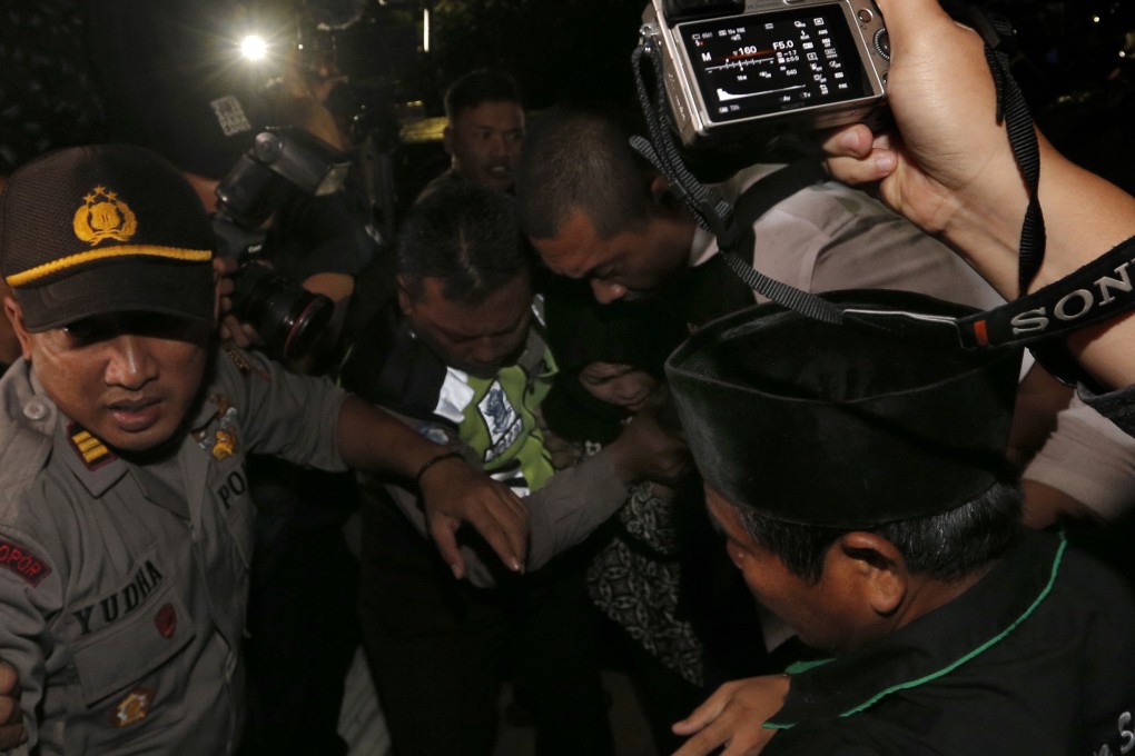 A crush of media and well-wishers greet Siti Aisyah, centre, as she arrives at her home village of Rancasumur on Tuesday evening. Photo: AP