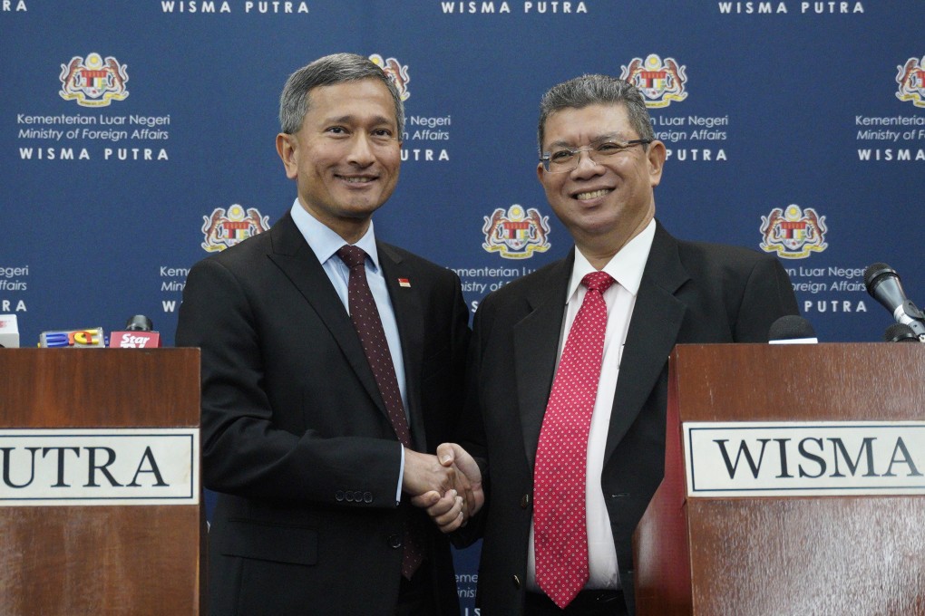 Singapore’s Foreign Minister Vivian Balakrishnan, left, and his Malaysian counterpart Saifuddin Abdullah in Putrajaya, Malaysia, on March 14. Photo: AP