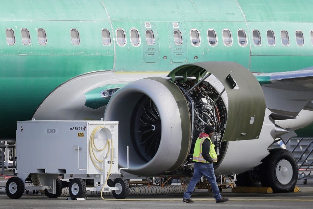 A worker walks past an engine on a Boeing 737 MAX plane being built for American Airlines. Photo: AP