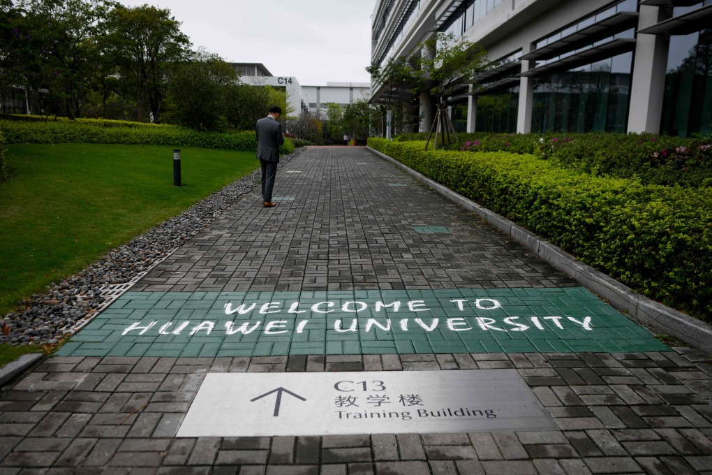A Huawei staff member uses his mobile phone at a Huawei production base in Dongguan, Guangdong province on March 6. Photo: AFP