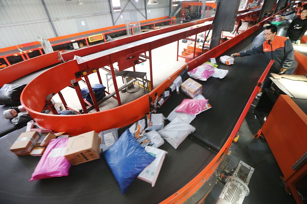 Employees work at a distribution centre of a delivery company in eastern China's Jiangsu province. The country’s major e-commerce companies are sharpening their focus on consumers in smaller cities to help boost consumption amid slowing growth. Photo: Xinhua