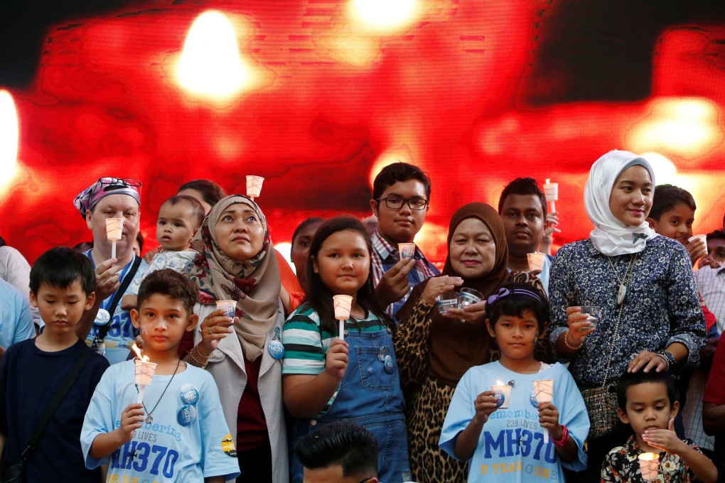 Family members hold candles during the fifth annual remembrance event for missing Malaysia Airlines flight MH370, in Kuala Lumpur, Malaysia on March 3. Photo: Reuters