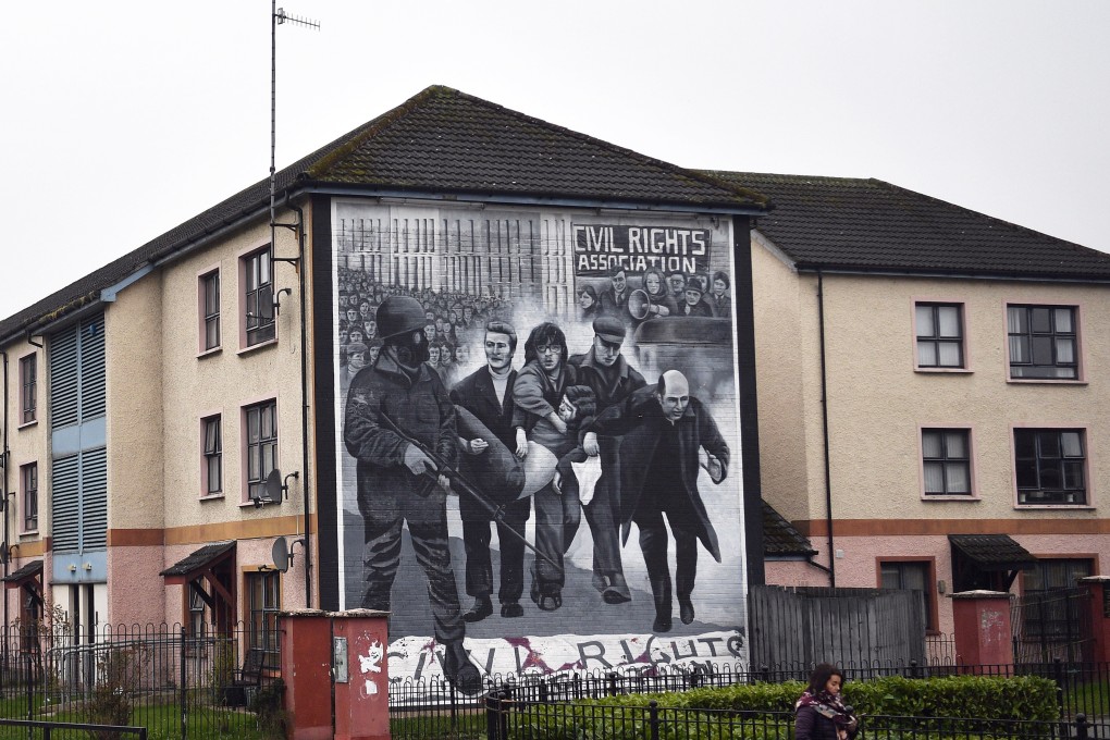 A mural depicting a priest Edward Daly (R) waving a bloodstained handkerchief as one of the victims of the 'Bloody Sunday', Jackie Duddy, is carried to safety. Photo EPA-EFE