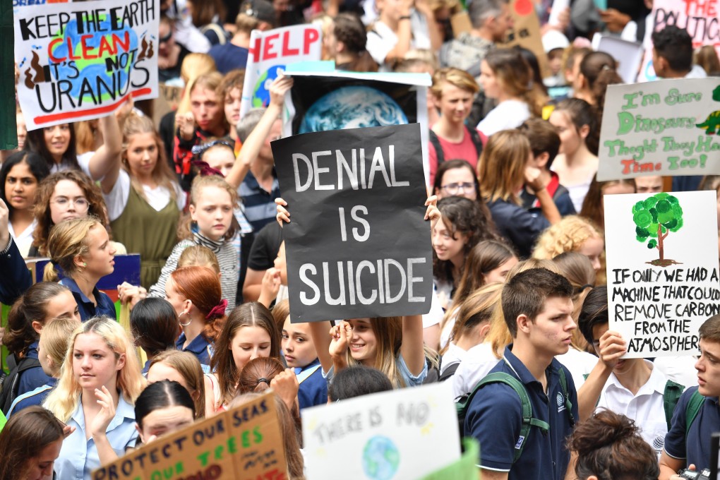 Youg people from schools across Sydney rally in front of the city’s Town Hall demanding climate action. Photo: EPA