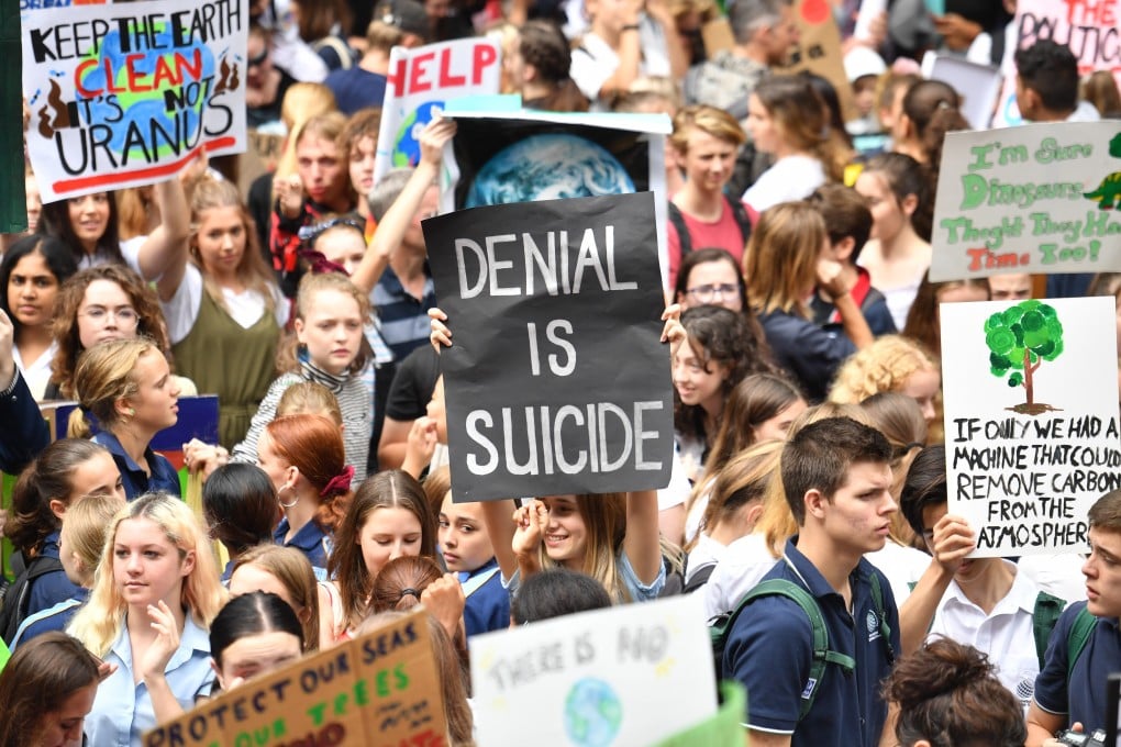 Youg people from schools across Sydney rally in front of the city’s Town Hall demanding climate action. Photo: EPA