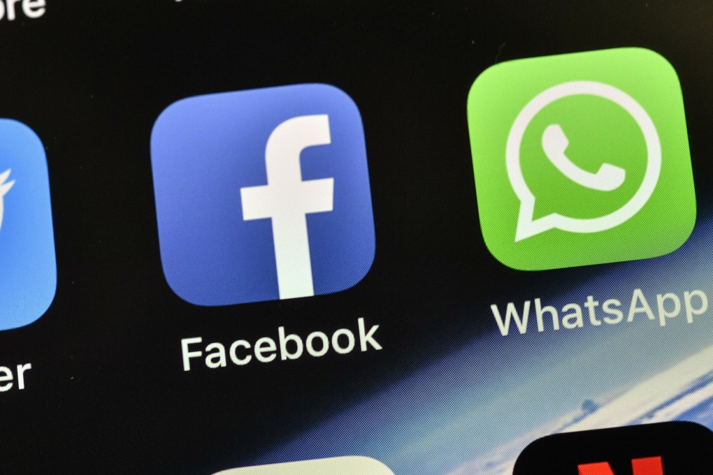 File photo the icons of Facebook and WhatsApp on a phone. Photo: AP