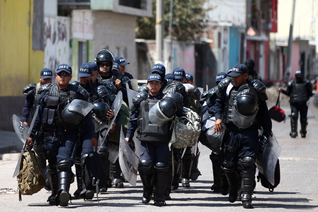 Police officers patrol a street in Santa Rosa de Lima, Guanajuato state, Mexico on March 6, 2019. Photo: Reuters