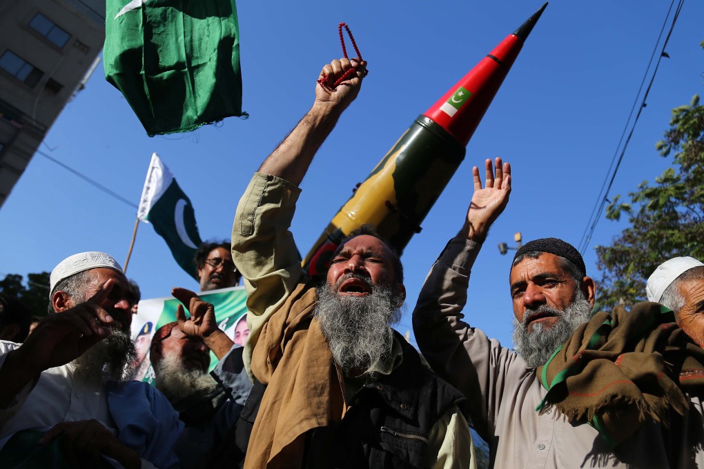 People hold replica of a Pakistani missile during a protest against India, in Karachi, earlier this month. Photo: EPA