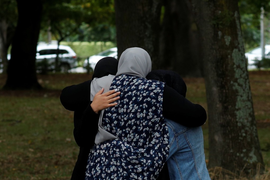People embrace near Masjid Al Noor mosque in Christchurch, New Zealand. Photo: Reuters