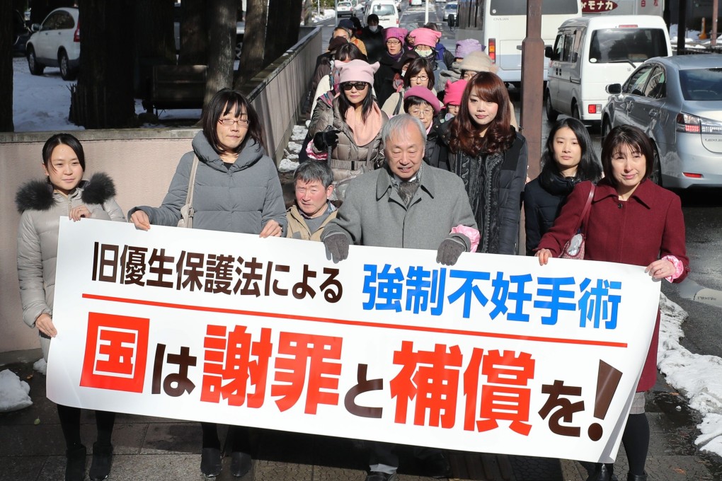 Lawyers and supporters of a woman seeking damages over her forced sterilisation march on January 30 last year. Photo: Kyodo