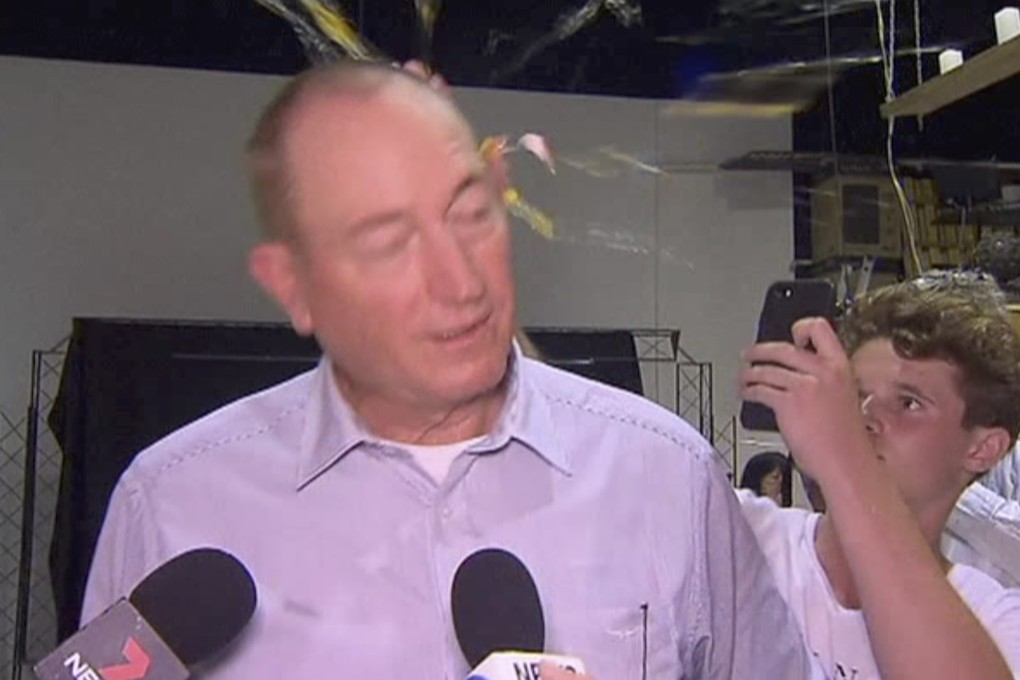 Senator Fraser Anning was approached from behind at a political event on Saturday, before having an egg cracked on the back of his head. Photo: AP