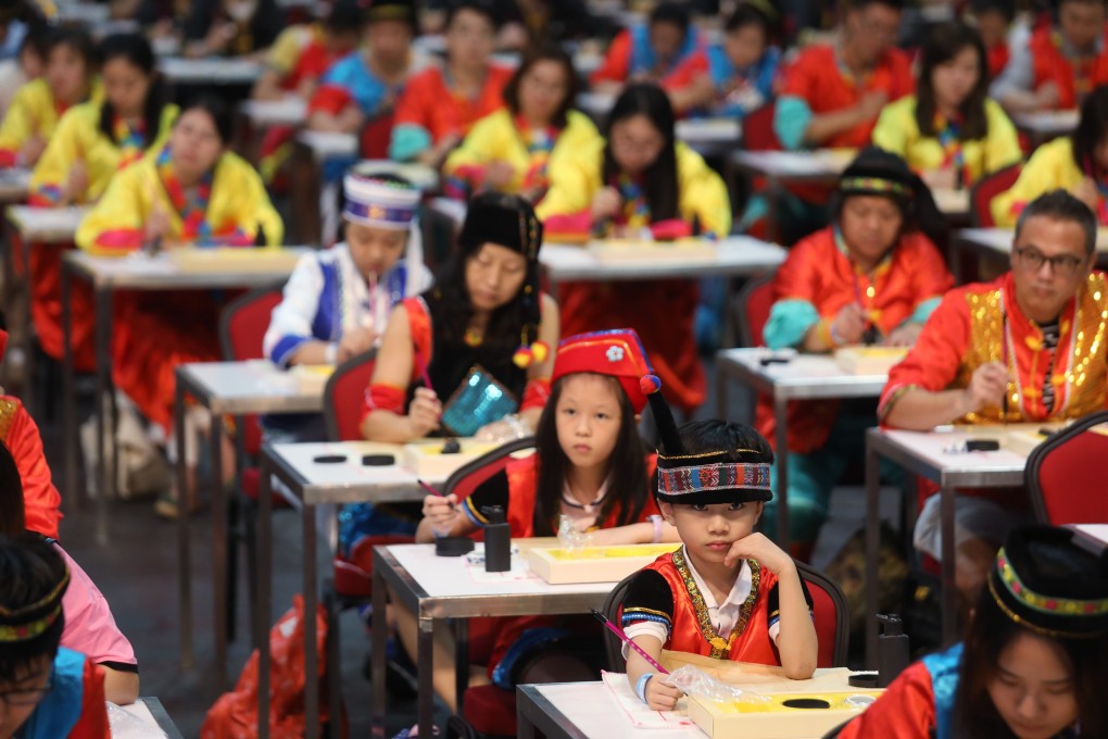 In an event organised by the Guangdong-Hong Kong-Macau Greater Bay Area Youth Association at AsiaWorld-Expo on September 25, 2018, participants wearing Chinese ethnic costumes attempt to set a world record for the largest calligraphy class. Photo: Xiaomei Chen