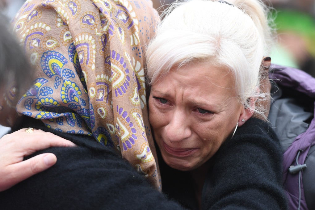 People comfort each other as they pay their respects to the victims of the Christchurch terrorist attack. Photo: Xinhua