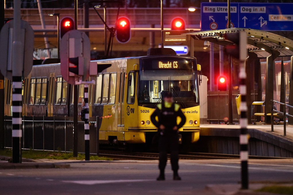 A policeman stands guard near a tram where a gunman opened fire killing at least three persons and wounding several on March 18, 2019 in Utrecht. Photo: AFP/John Thys