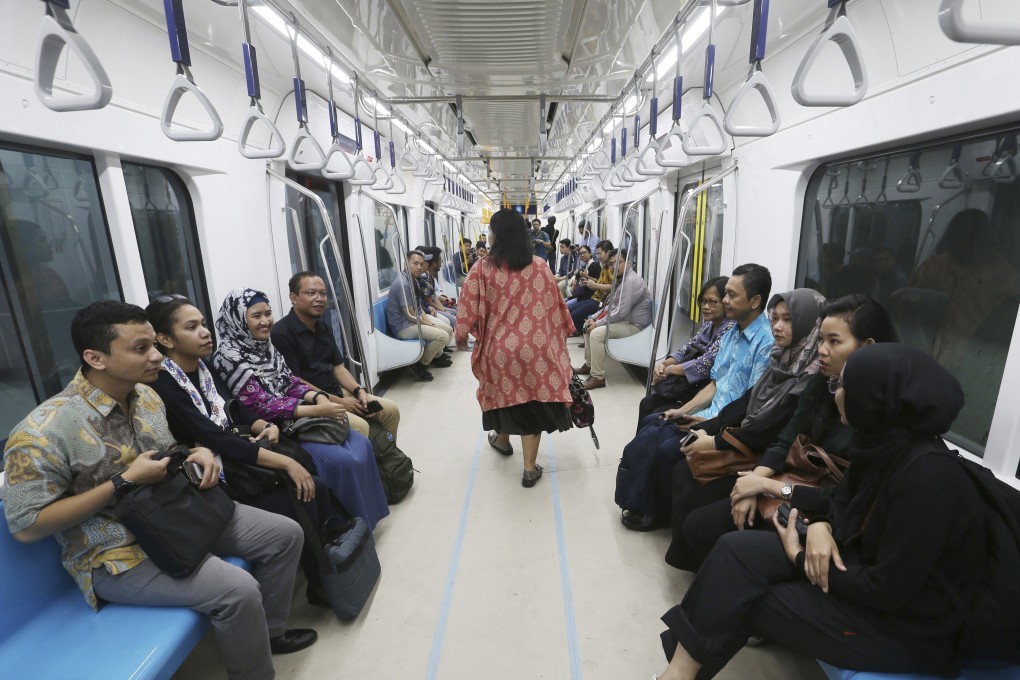 People ride on an Mass Rapid Transit (MRT) train during a trial run in Jakarta. Photo: AP