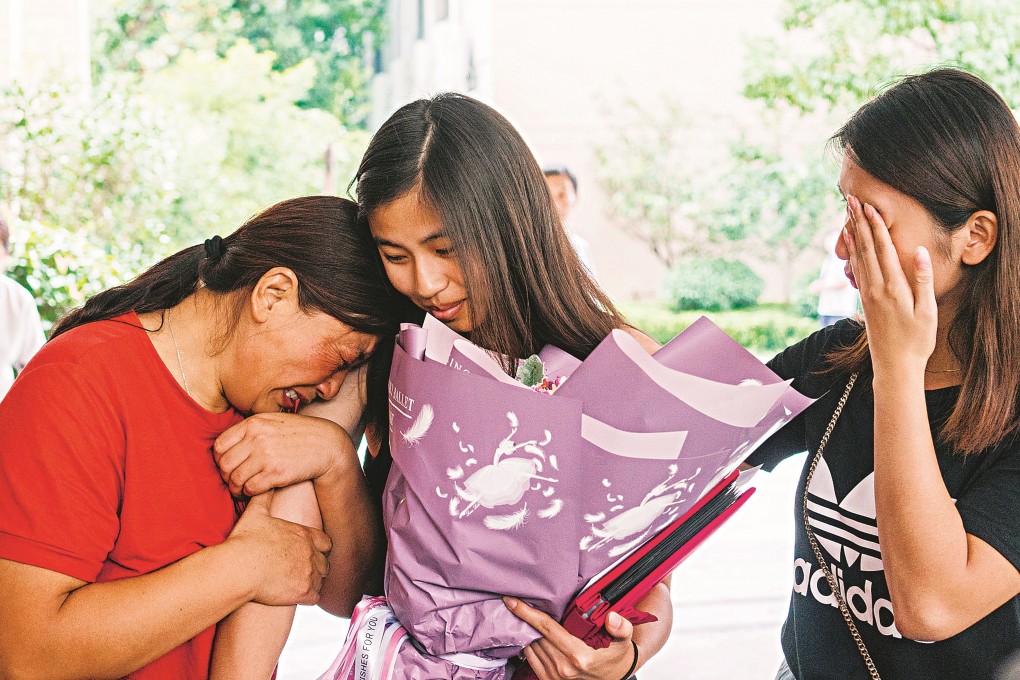 Lianna Fogg (centre), adopted as a child by a couple from Philadelphia in the United States, has an emotional reunion with her biological mother and sister in Anhui province, China. Photo: Zou Biyu