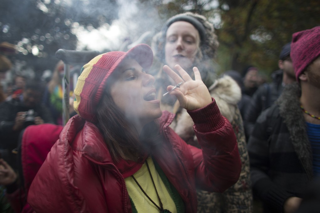 Some Canadian mothers say cannabis makes them better parents. Here a woman smokes a marijuana cigarette during a legalisation party in Toronto. Photo: AFP
