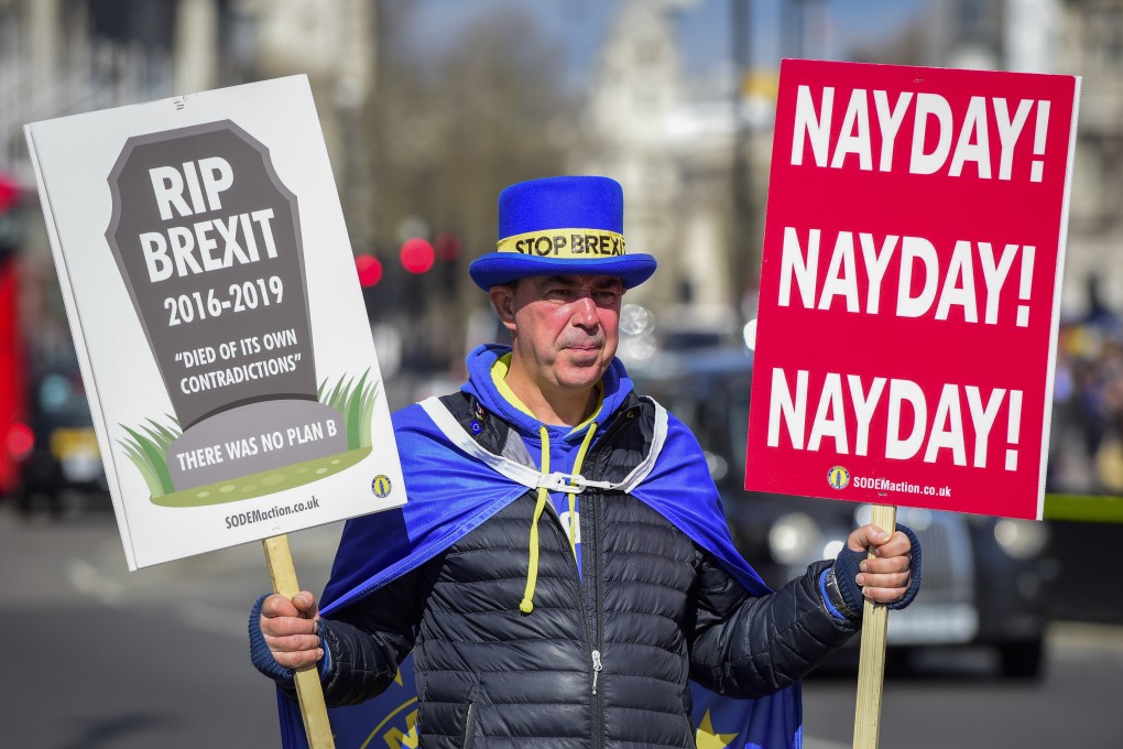 An anti-Brexit protester holds placards outside the Houses of Parliament in London, Britain, on March 19, 2019. Photo: Xinhua/Stephen Chung