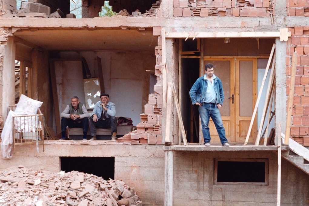 Serb civilians sit in the ruins of their homes in Surdulica, 300km south of Belgrade, on April 28, 1999. Photo: AP
