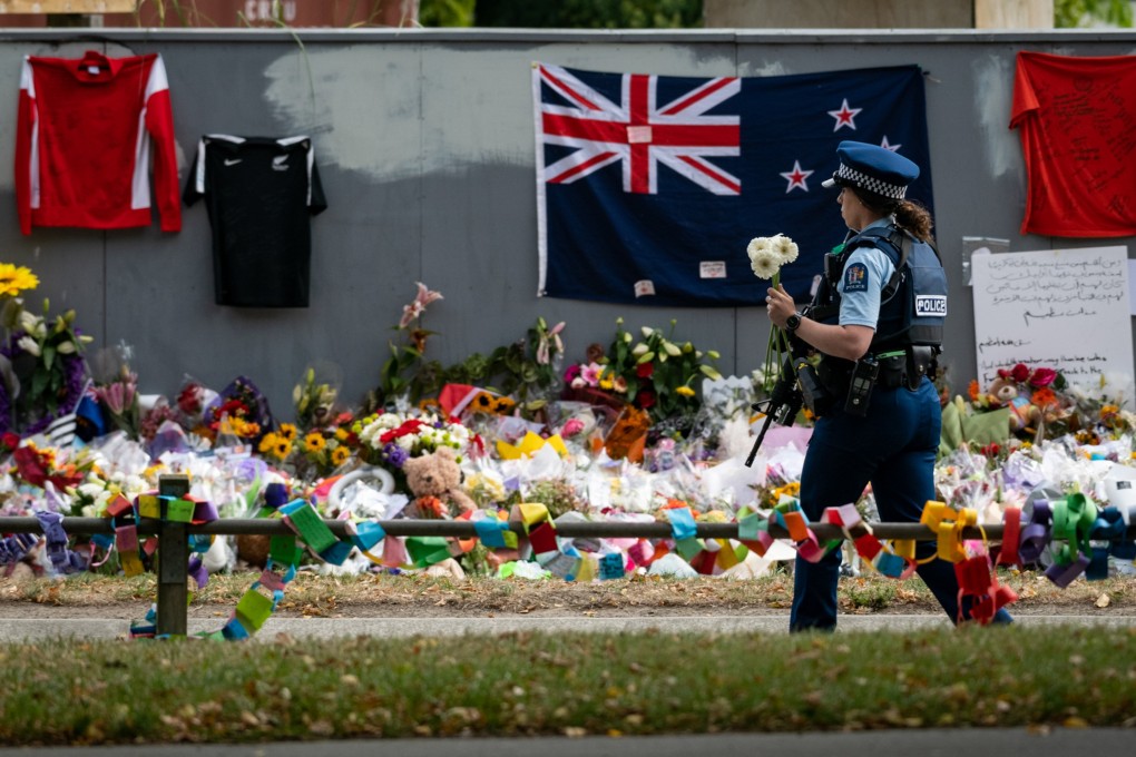 A policewoman holds flowers during a mourning ceremony in Christchurch, New Zealand, on Friday. Photo: Xinhua