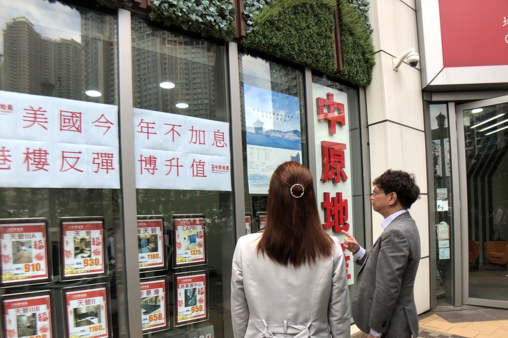 A Hong Kong property agent advertises the decision by the US Federal Reserve not to increase interest rates this year, and the possibility of a consequent rebound in home prices, on Thursday. Photo: Handout