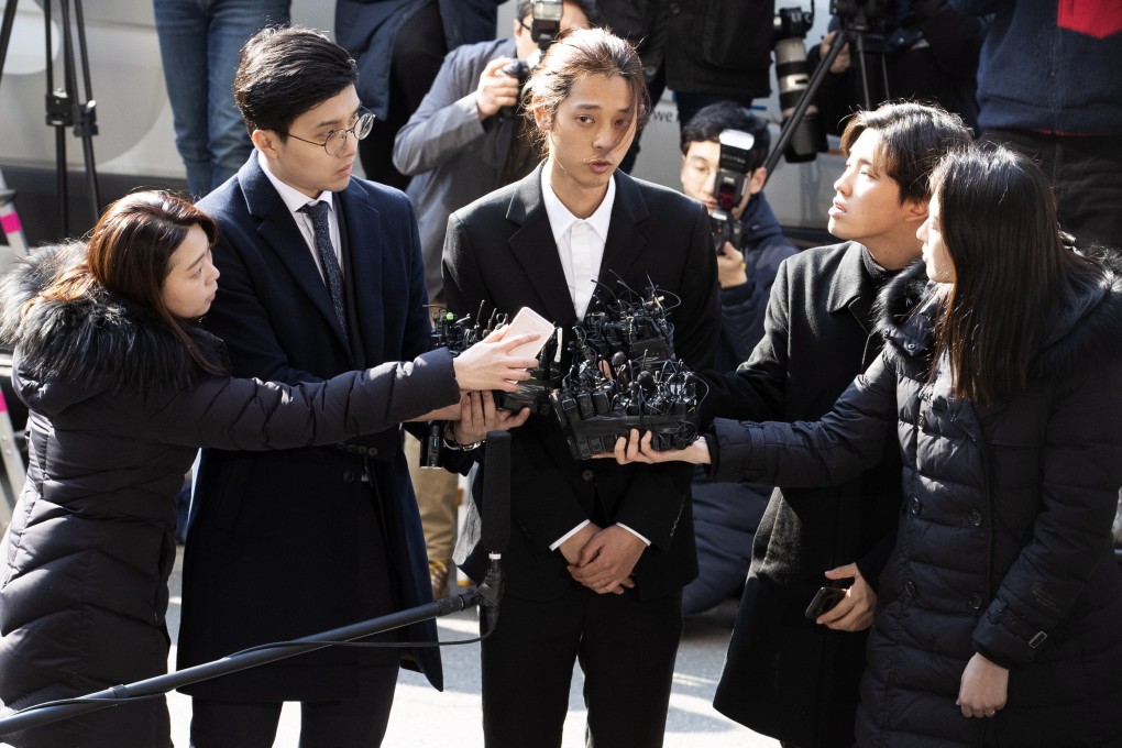 South Korean singer Jung Joon-young (centre) talks to reporters on March 14 after arriving at the Metropolitan Police Agency in Seoul, South Korea. Photo: EPA-EFE/Yonhap