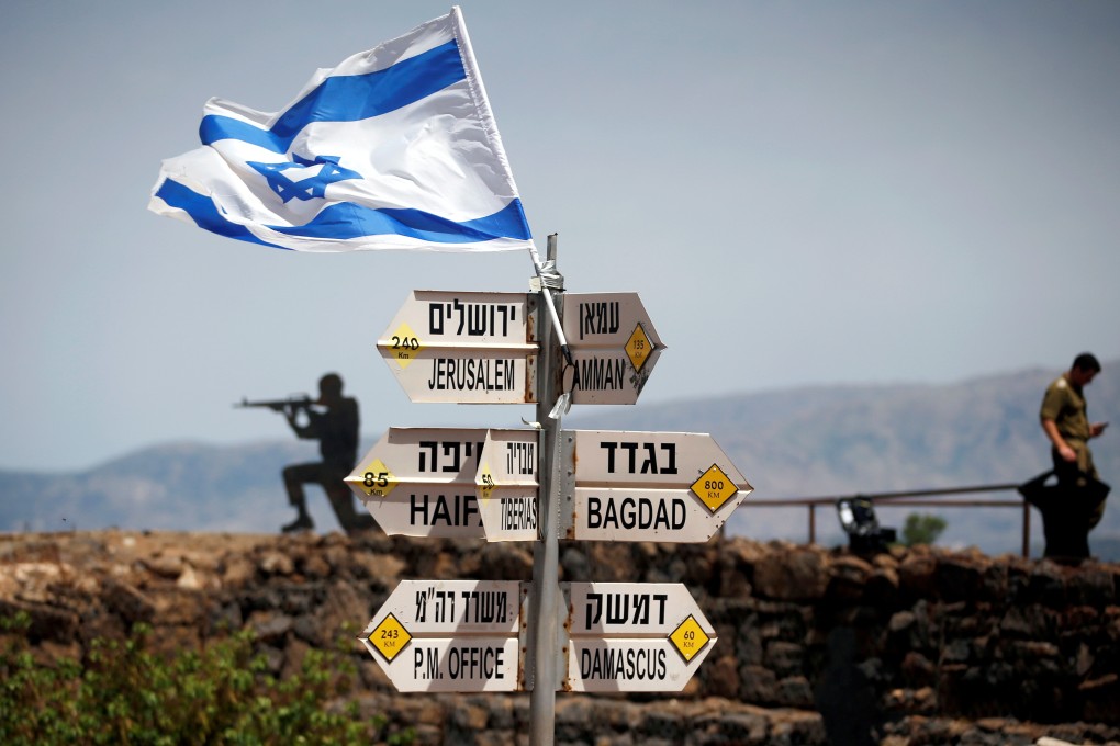 A file photo showing an Israeli soldier standing next to signs pointing out distances to different cities, on Mount Bental, an observation post in the Israeli-occupied Golan Heights that overlooks the Syrian side of the Quneitra crossing. Photo: Reuters