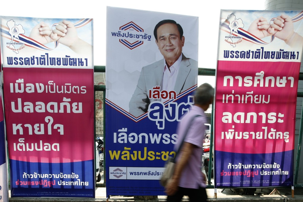 A pedestrian walks past an election campaign poster featuring a portrait of Thai Prime Minister and junta leader Prayuth Chan-ocha. Thailand is set to hold a general election on March 24, the first poll in five years since the 2014 military coup. Photo: EPA