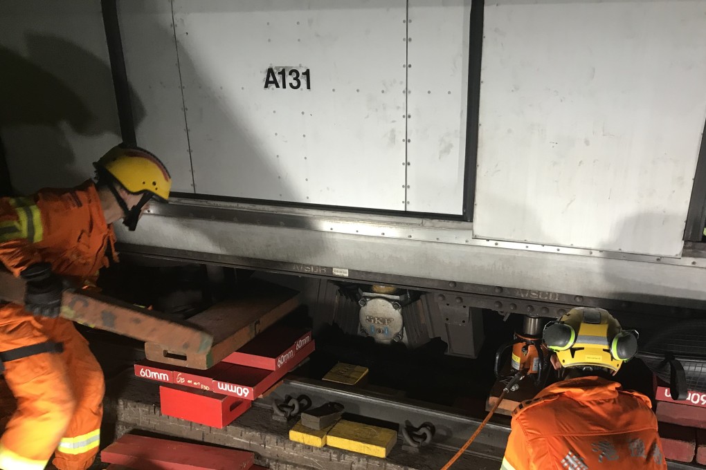 Fire service officers helping with remove the derailed MTR train. Photo: Handout