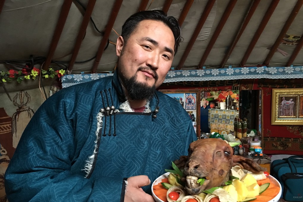 Naranbaatar Tsambakhorloo, host of the YouTube channel ArtGer’s flagship programme, Nargie’s Mongolian Cuisine, holding a scorched lamb’s face. Photo: courtesy of ArtGer