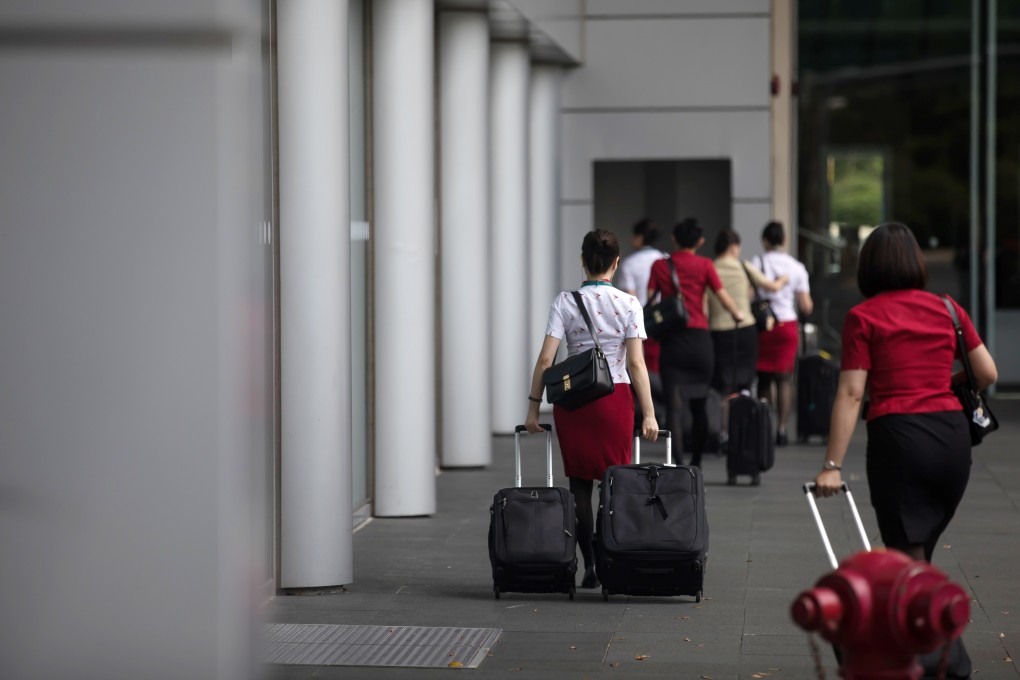 Two Cathay staff members, two baggage handlers and a security guard, all working at Hong Kong International Airport have been taken ill in the past eight days. Photo: Bloomberg