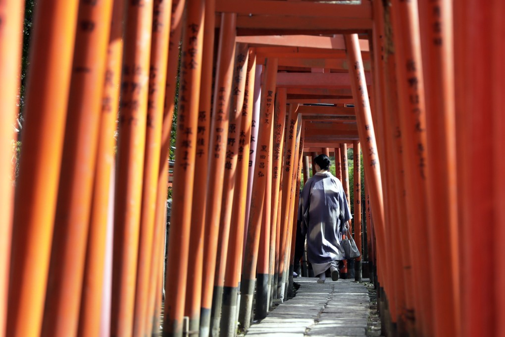 A tourist visits the Otome Inari Shrine in Tokyo. The demand in Japan for accommodation such as hotels has never been higher, according to one industry insider. Photo: Bloomberg