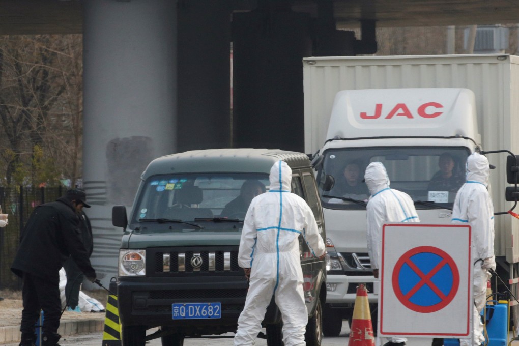 Workers in protective suits are seen at a checkpoint on a road leading to a village near a farm where African swine fever was detected, in Fangshan district of Beijing, China on November 23, 2018. Photo: Reuters