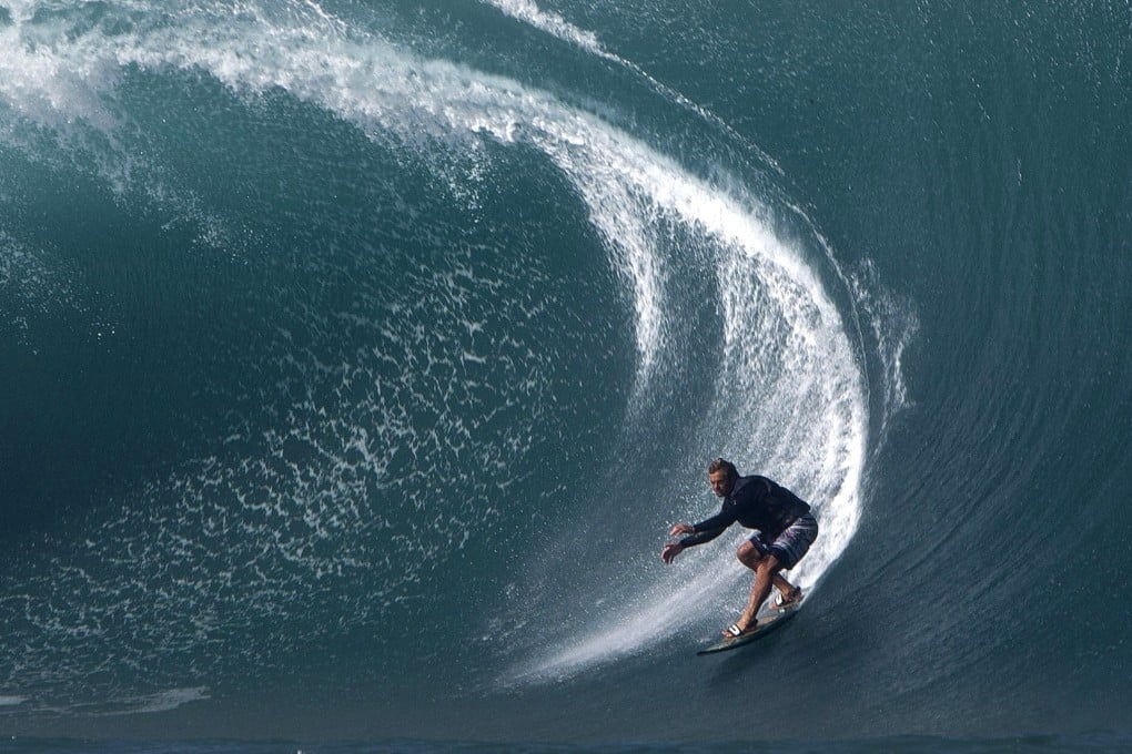 US surfer Laird Hamilton rides a wave at Teahupoo in Tahiti. Hamilton is among the elite athletes to have adopted the Wim Hof Method to improve performance. Photo: AFP