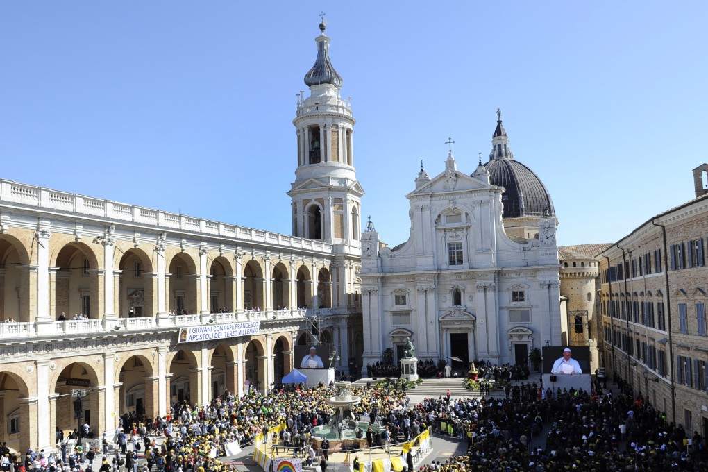 Pope Francis is shown on a giant screen in Loreto in central Italy on Monday. Photo: AP