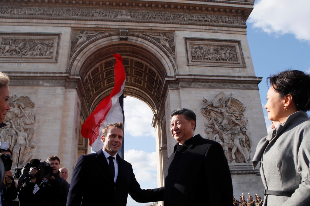 French President Emmanuel Macron, his wife Brigitte Macron, Chinese President Xi Jinping and his wife Peng Liyuan leave the Arc de Triomphe monument after a wreath-laying ceremony at the Tomb of the Unknown Soldier, in Paris on Monday. Photo: Reuters