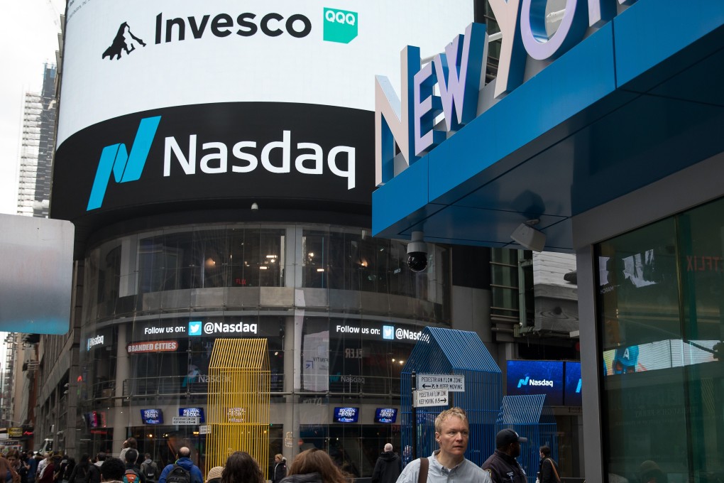 Pedestrians pass in front of the Nasdaq MarketSite in the Times Square neighbourhood of New York on March 15, 2019. Photo: Bloomberg